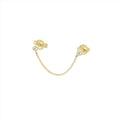 De massief gouden vintage zirconia studs verbonden door een kettinkje.