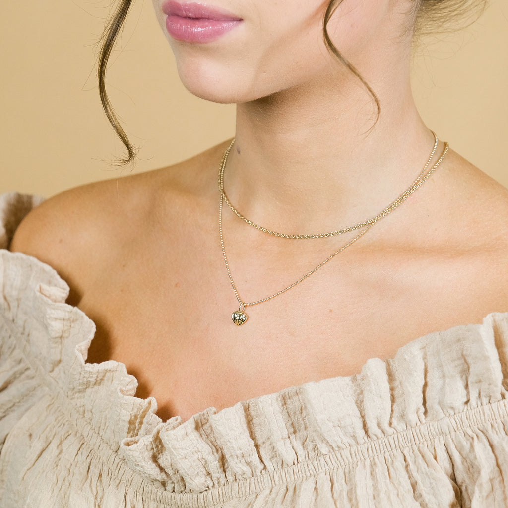 Wearing the solid gold vintage heart necklace pendant with the solid gold twisted necklace.