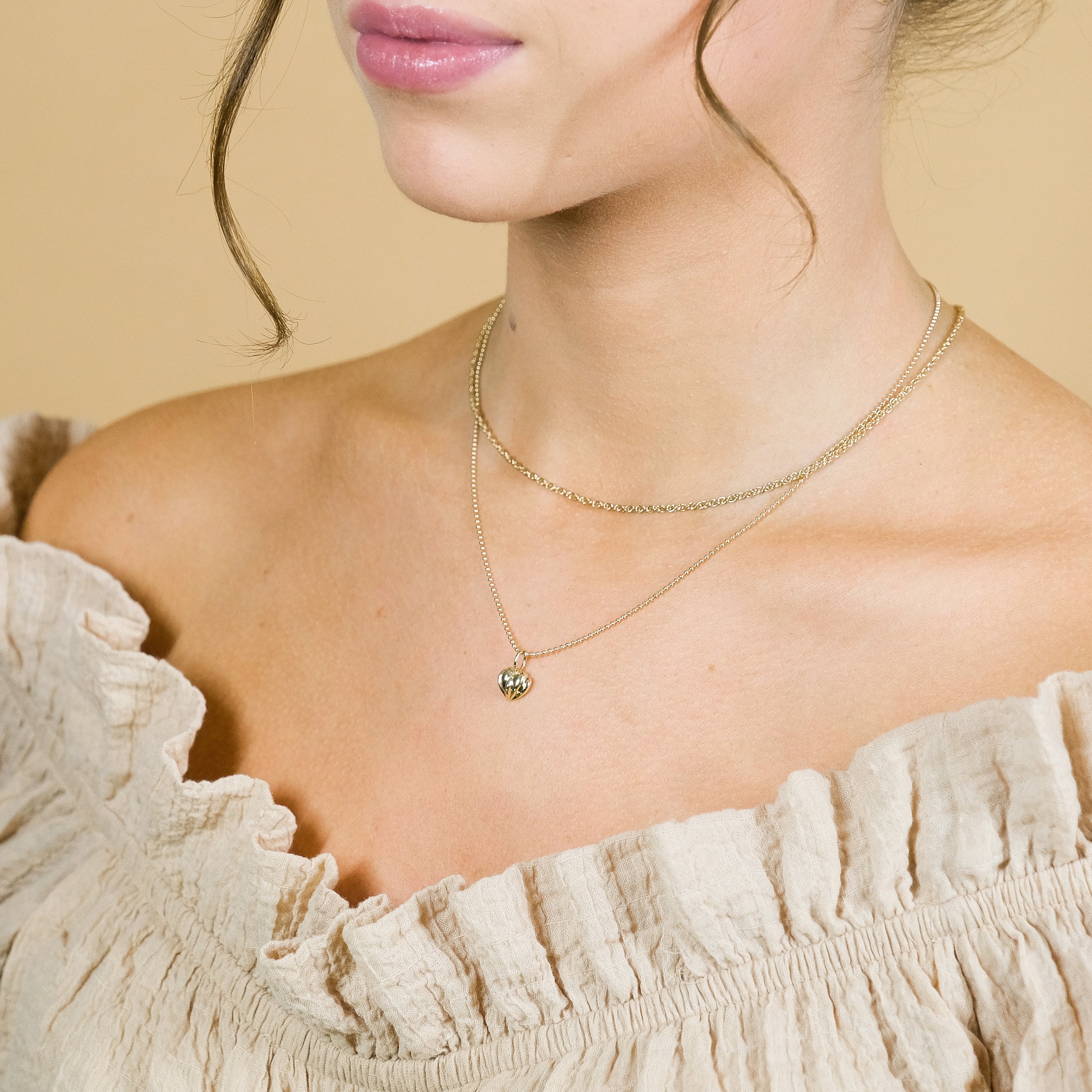 Wearing the solid gold vintage heart necklace pendant with the solid gold twisted necklace.