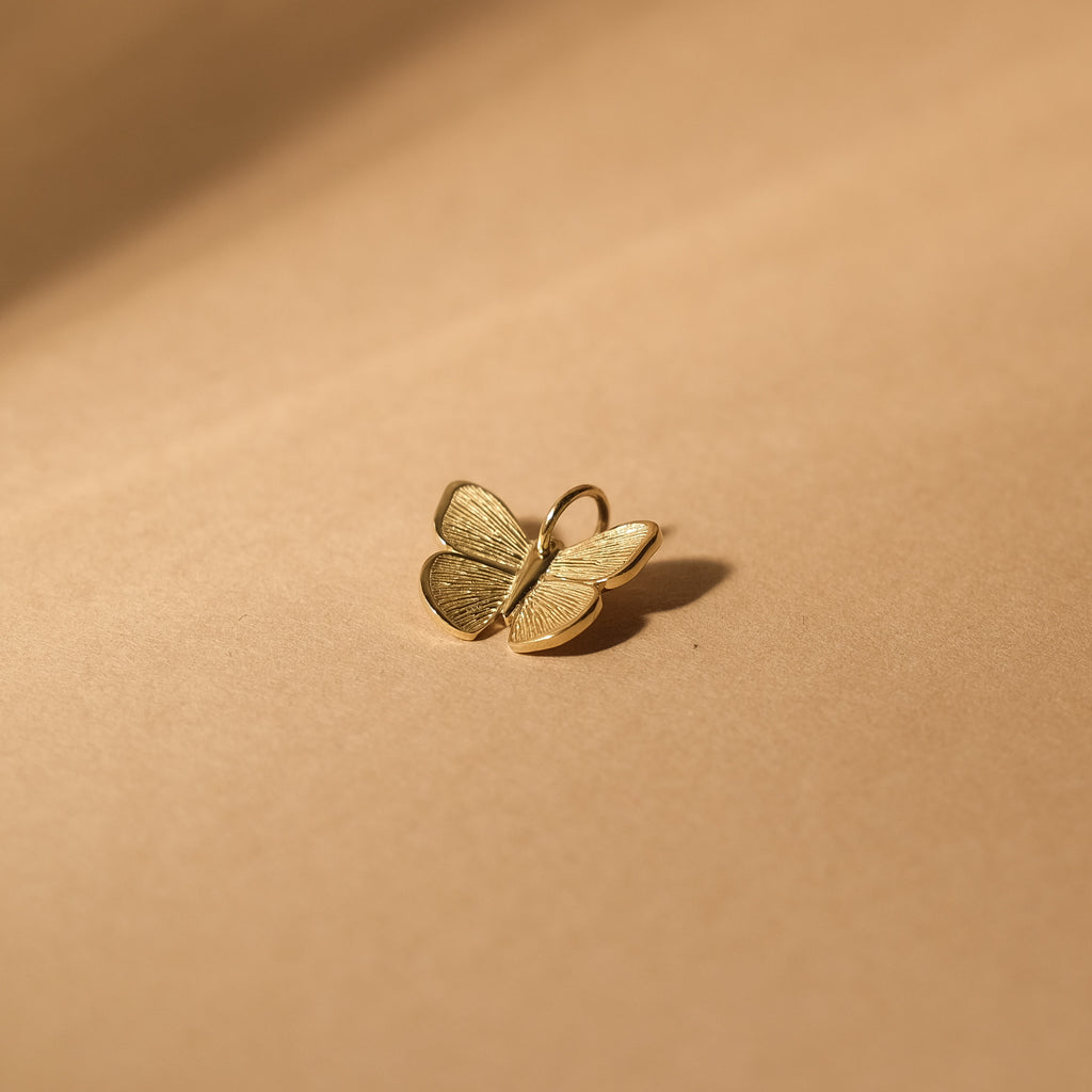 The MiJu Official solid gold butterfly necklace pendant.