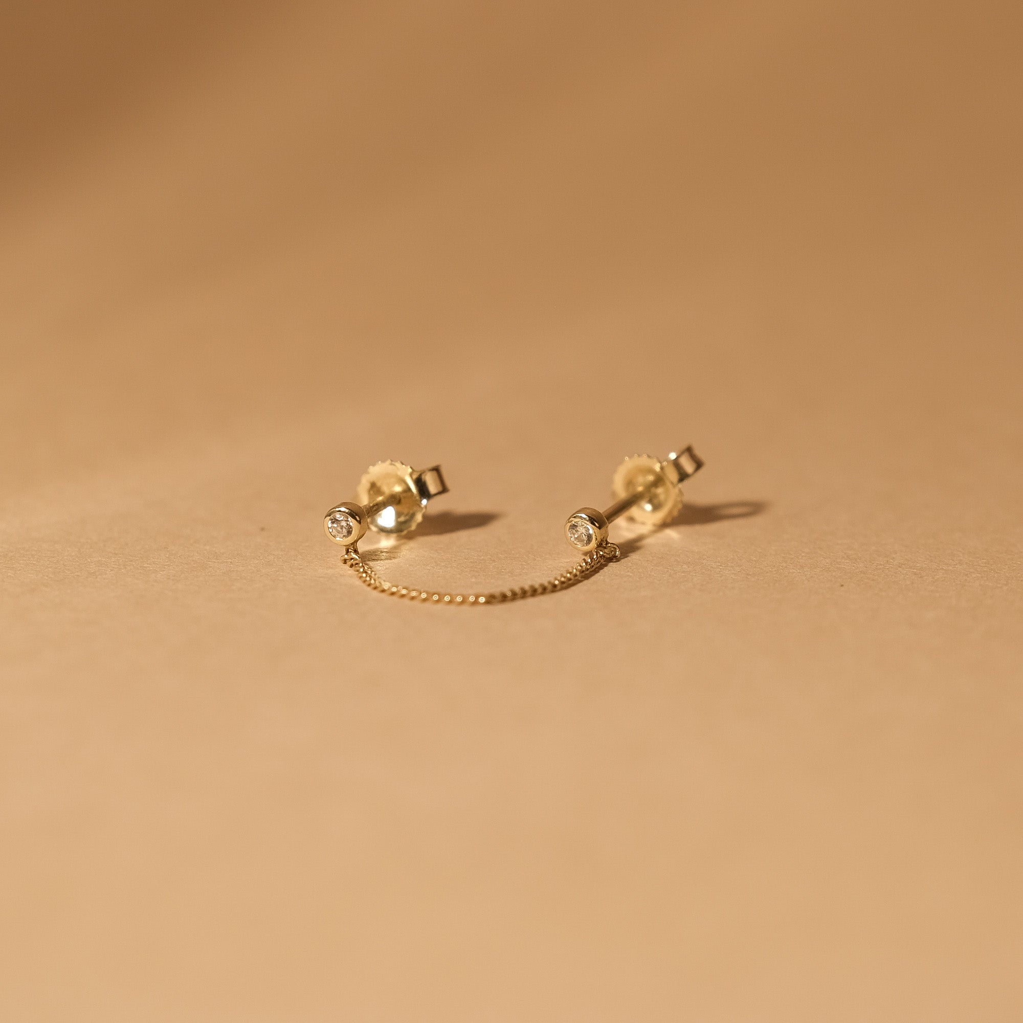 The MiJu Official solid gold vintage chain stud with two small cubic zirconia gemstones.