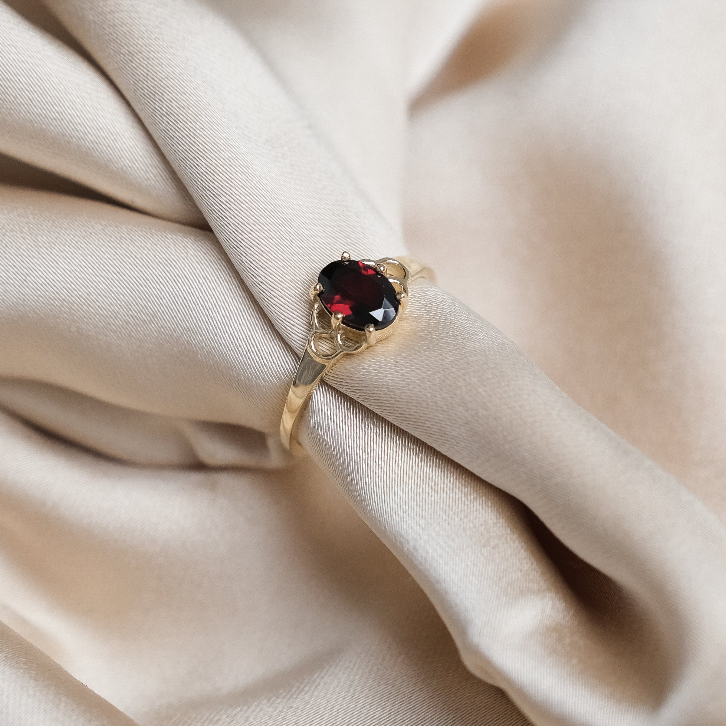 De 9 karaats gouden MiJu Official mermaid ring met een granaat edelsteen.